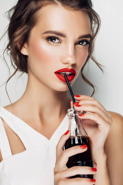 istock Beautiful woman drinking soda 815975102