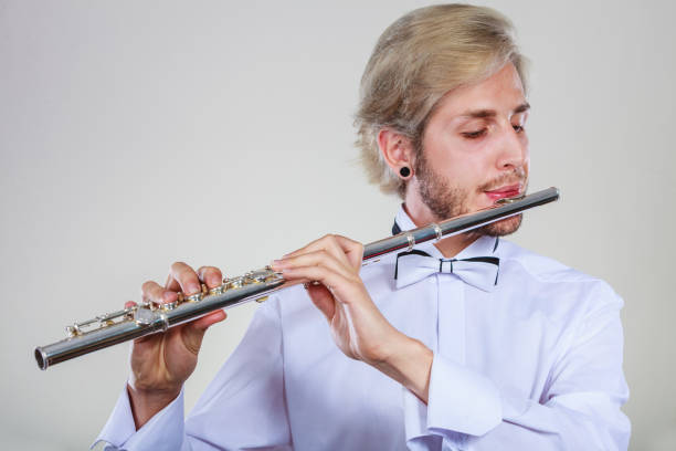 istock Male flutist playing his flute 815989270