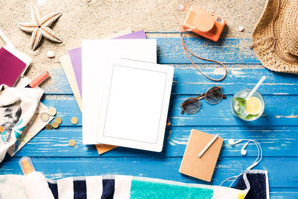 istock White blank magazine on blue wooden platform with summer accessories 815993870