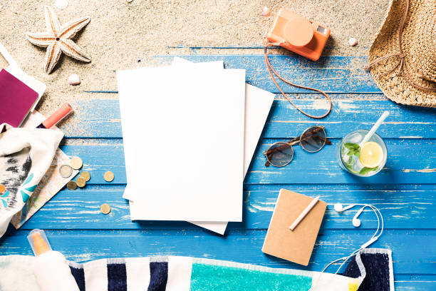 istock White blank magazine on blue wooden platform with summer accessories 816000234