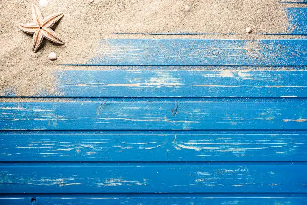 Photo of Blue wooden platform with beach sand