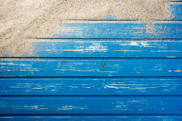 istock Blue wooden platform with beach sand 816035248