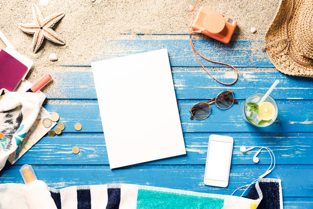 istock White blank magazine on blue wooden platform with summer accessories 816039398