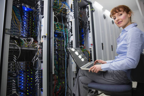 istock Technician sitting on swivel chair using laptop to diagnose servers 816039754