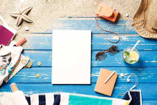 istock White blank magazine on blue wooden platform with summer accessories 816050760