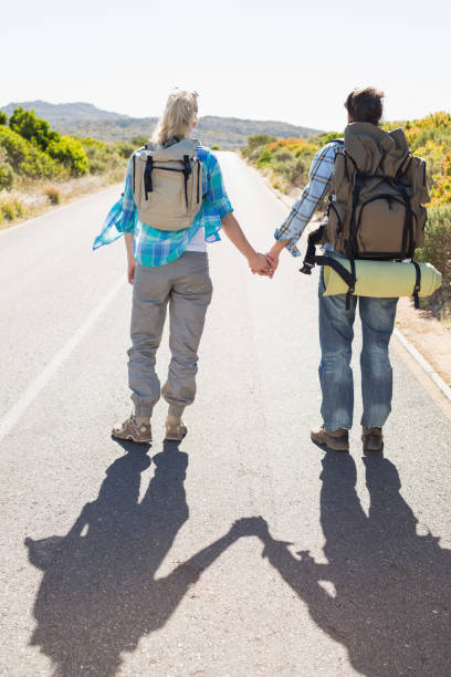 istock Attractive couple standing on the road holding hands 816058134