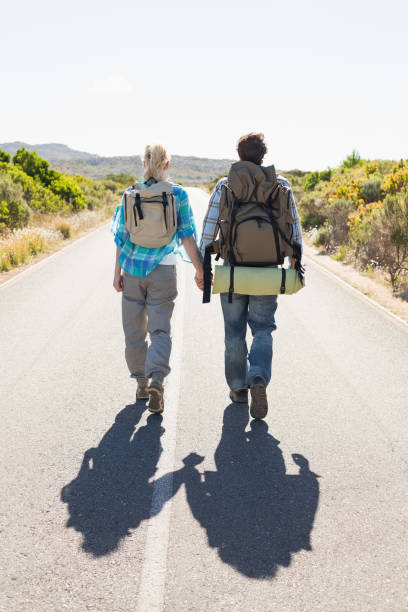 istock Attractive couple walking on the road holding hands 816062352