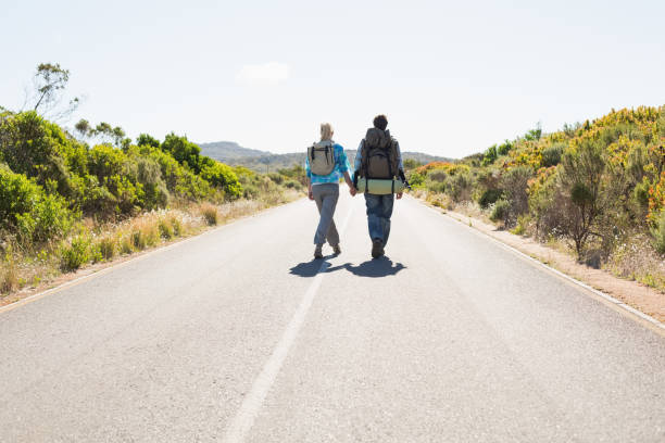 istock Attractive couple walking on the road holding hands 816064924