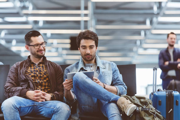 istock Handsome men waiting for flight in airport terminal 816086208