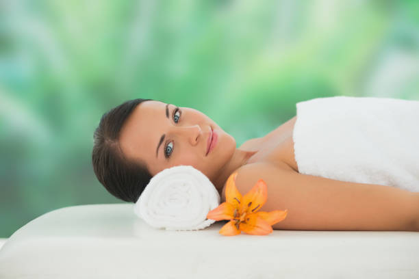 istock Beautiful brunette relaxing on massage table smiling at camera 816096392