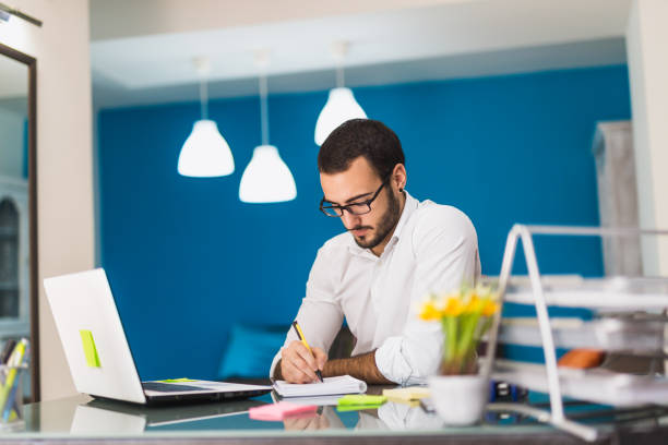 istock Young businessman writing with his pen 816104982