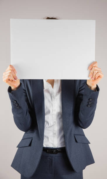 istock Businesswoman holding card over face 816105126