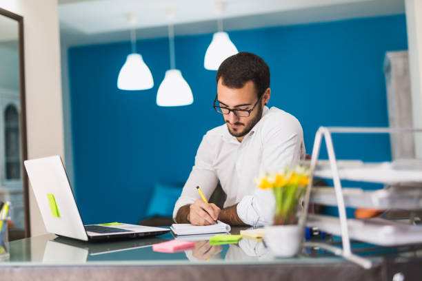istock Young businessman writing with his pen 816107340