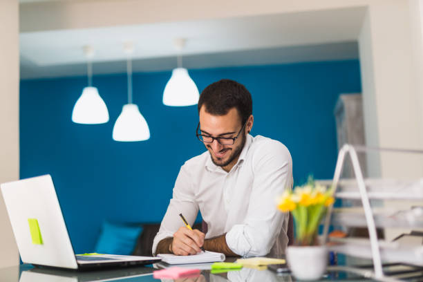 istock Young businessman writing with his pen 816109716