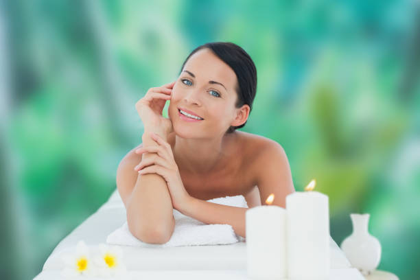 istock Beautiful brunette relaxing on massage table smiling at camera 816119316