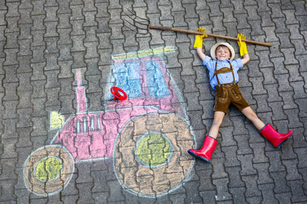 istock little kid boy having fun with tractor chalks picture 816119734