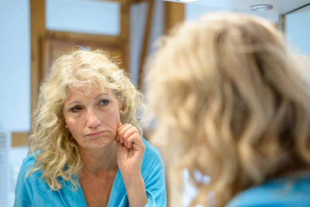 istock Senior blond woman checking her ageing skin 816121944