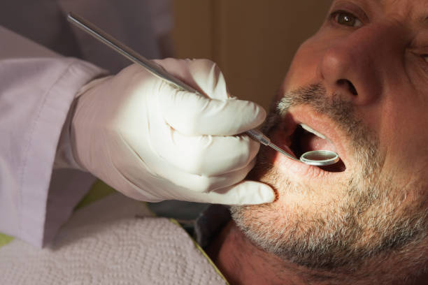 istock Dentist examining a patients teeth in the dentists chair 816122712
