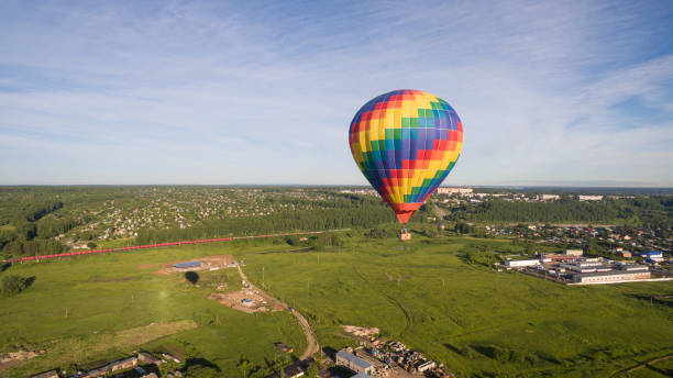 istock Rainbow balloon over village 816127262