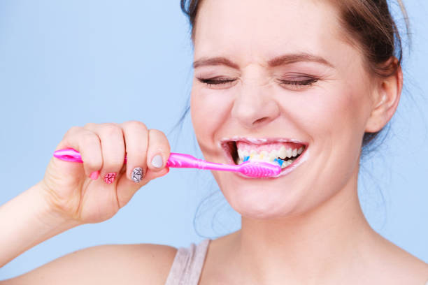 istock Woman brushing cleaning teeth 816129702