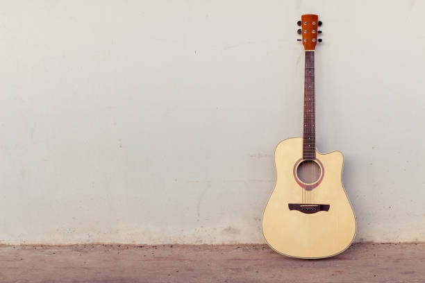 istock guitar on old wall, copy spaced,vintage tone. 816134532