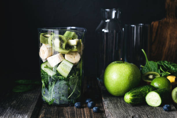 green smoothie and ingredients for smoothie - blender apple banana color image imagens e fotografias de stock