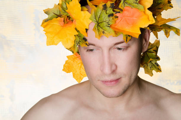 istock Autumn. A handsome man and orange foliage. Day. The sun. 816152810