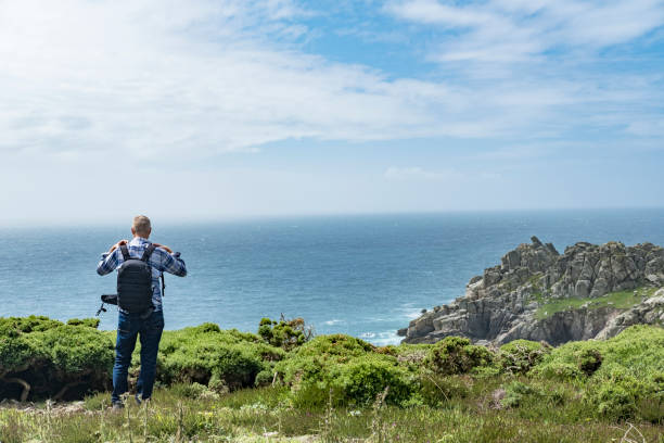 istock Man stood on cliffs enjoying the South Cornish coast, near Porthcurno. 816174212