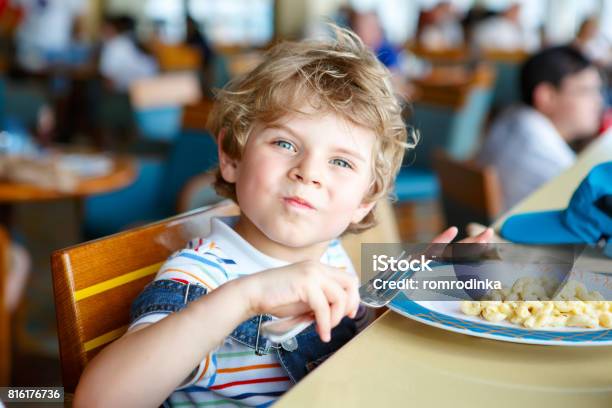 Cute Healthy Preschool Boy Eats Pasta Sitting In School Canteen Stock Photo - Download Image Now