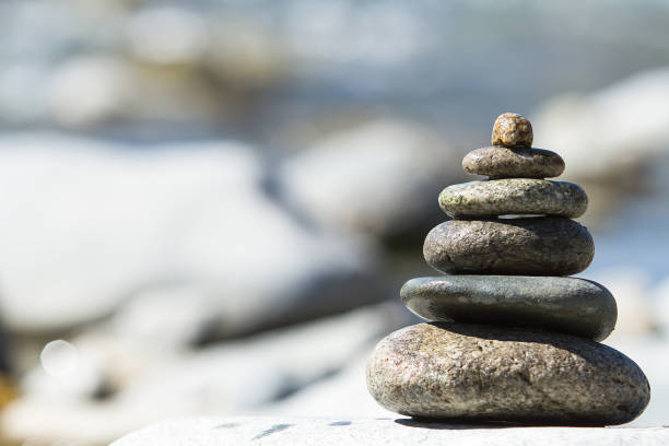 istock Stones pyramid on pebble beach symbolizing stability, zen, harmony, balance. 816180118