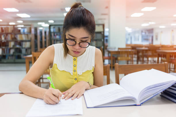 istock study education, woman writing on a paper, working women 816197894