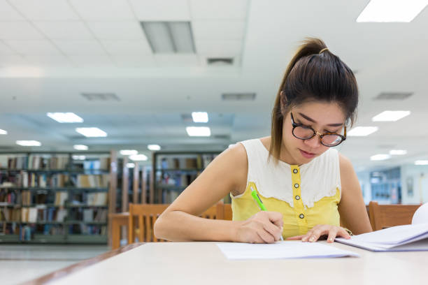 istock study education, woman writing on a paper, working women 816197928