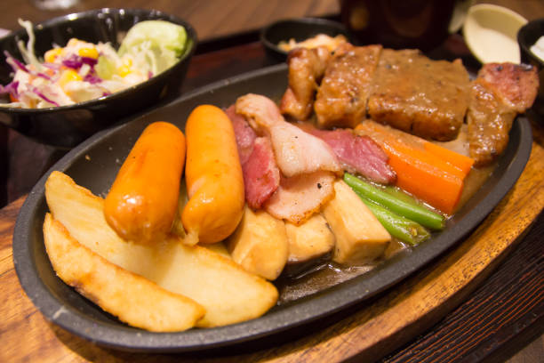 istock Grilled sausages vegetables in a pan grill on the table 816198134