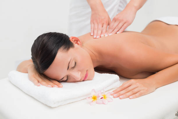istock Beautiful brunette enjoying a back massage 816198170