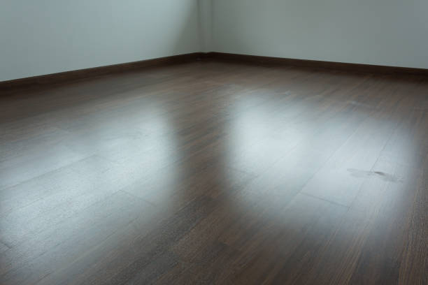 istock empty room interior, brown wood laminate floor and white mortar wall 816200524