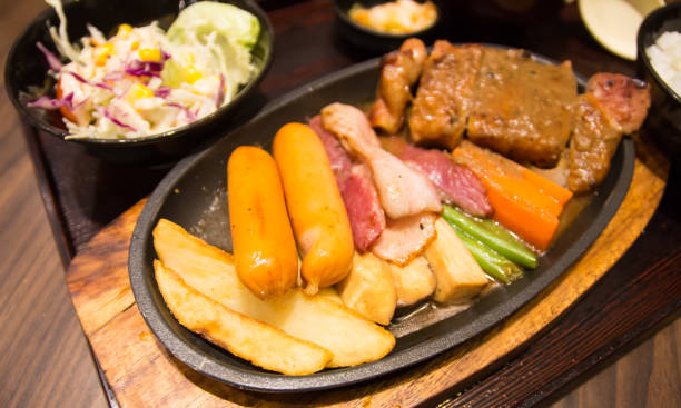 istock Grilled sausages vegetables in a pan grill on the table 816200824