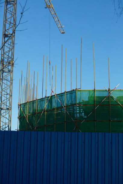 istock scaffolding and formwork in installation building fencing green tape on site. 816201014
