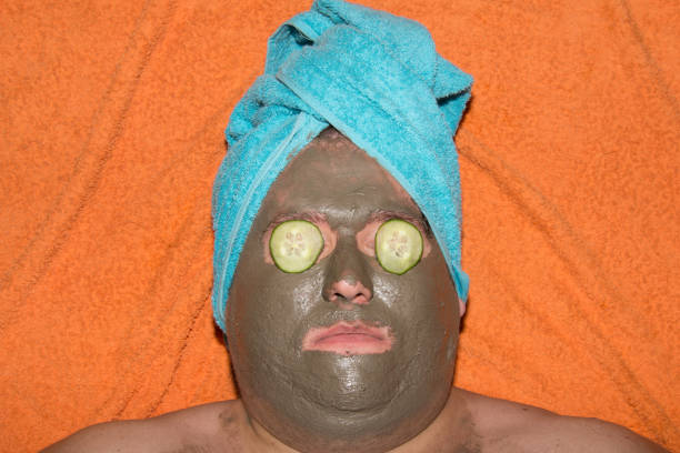 spa e trattamenti per il viso. buffo uomo grasso e maschera d'argilla. - mud wellbeing spa treatment beautician foto e immagini stock