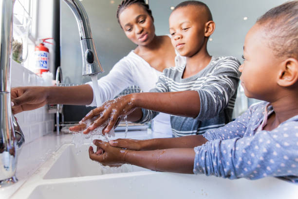 istock Family washing their hands together. 816219568