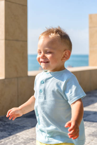 istock Summer,bright day, the boy blond closeup running and smiling. 816243286