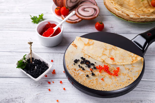 istock Pancakes in a frying pan with Salmon Caviar 816256980