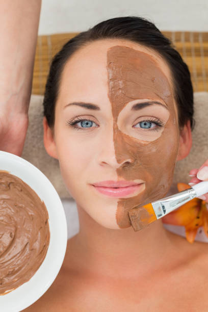 istock Peaceful brunette getting a mud facial applied 816260170