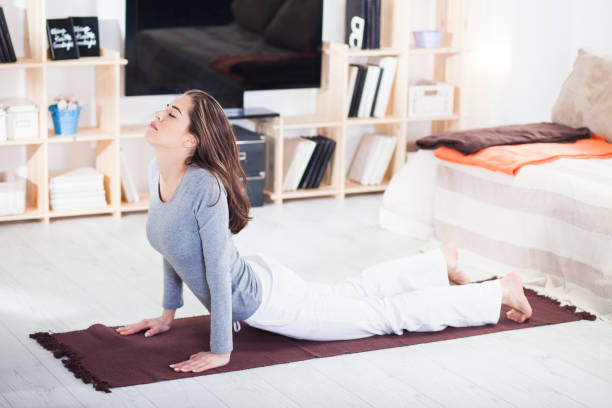 istock Fit woman doing yoga on mat 816263064