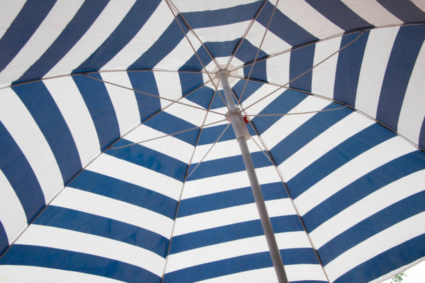 istock Blue and white color umbrellas background 816265382