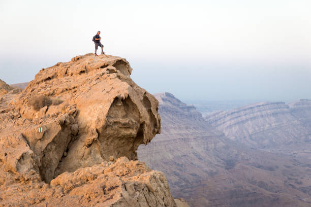 istock Backpacker tourist standing mountain cliff edge, crater landscape Israel. 816265510