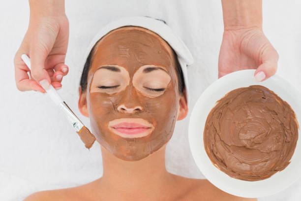 istock Smiling brunette getting a mud treatment facial 816265516