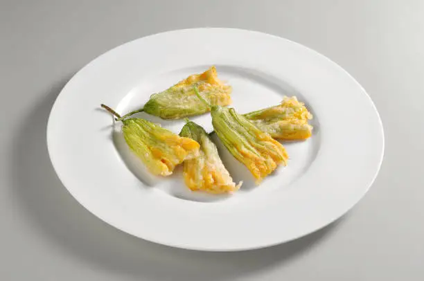 Photo of Round dish with a portion of tempura pumpkin flowers