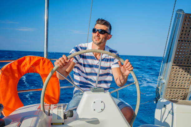 istock Young man sailing yacht 816282488