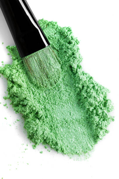 istock Broken green eye shadow and makeup brush isolated on white background 816287458