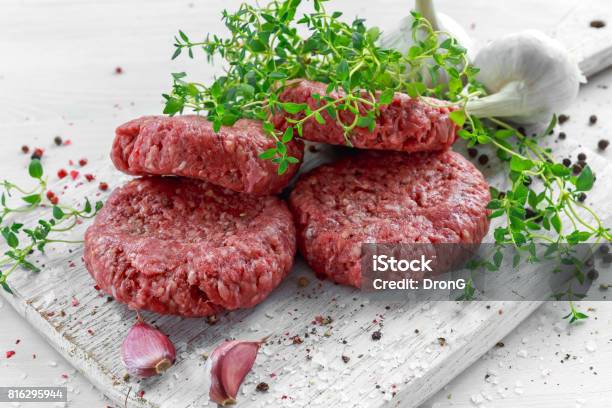 Home Handmade Raw Minced Beef Steak Burgers On Wooden Board Stock Photo - Download Image Now